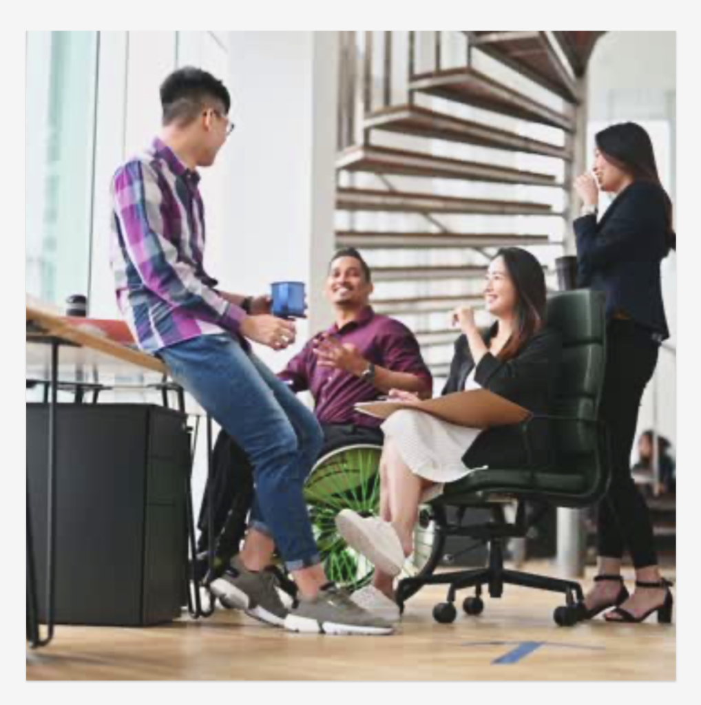 Group of 4 coworkers conversing